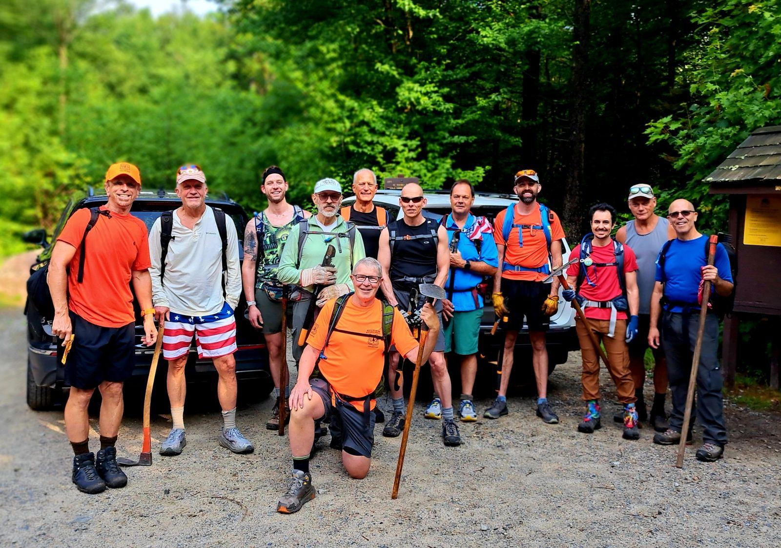 GayOutdoors volunteers with trail tools at a trailhead after a maintenance day